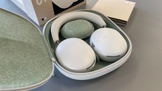 Sonos Ace noise-cancelling headphones in open case with box on grey surface